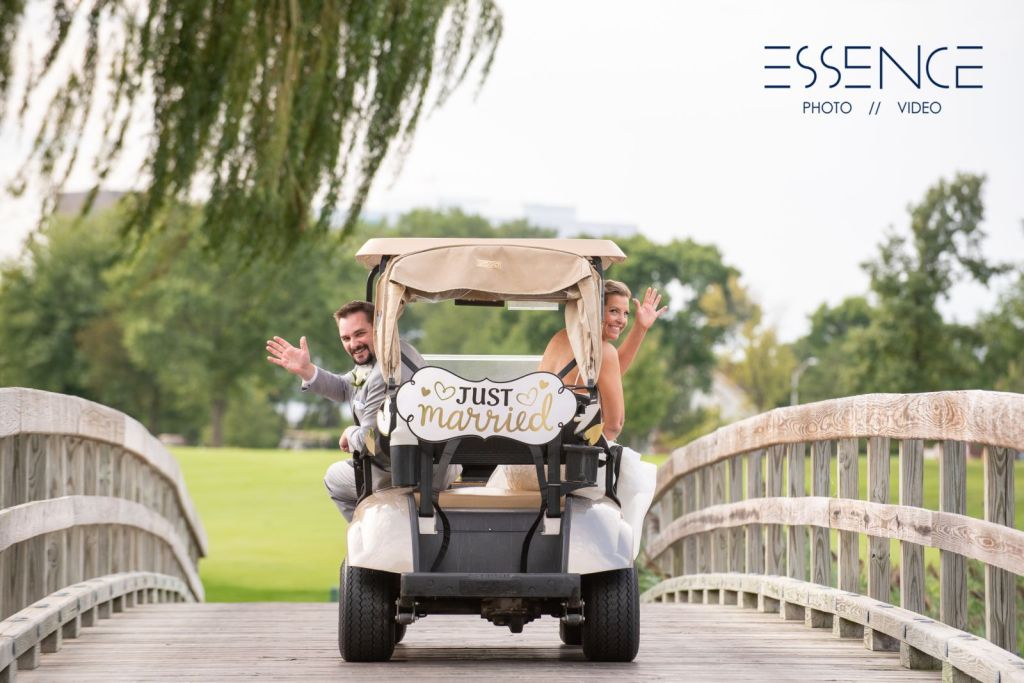 Married couple in golf cart with Just married sign 
