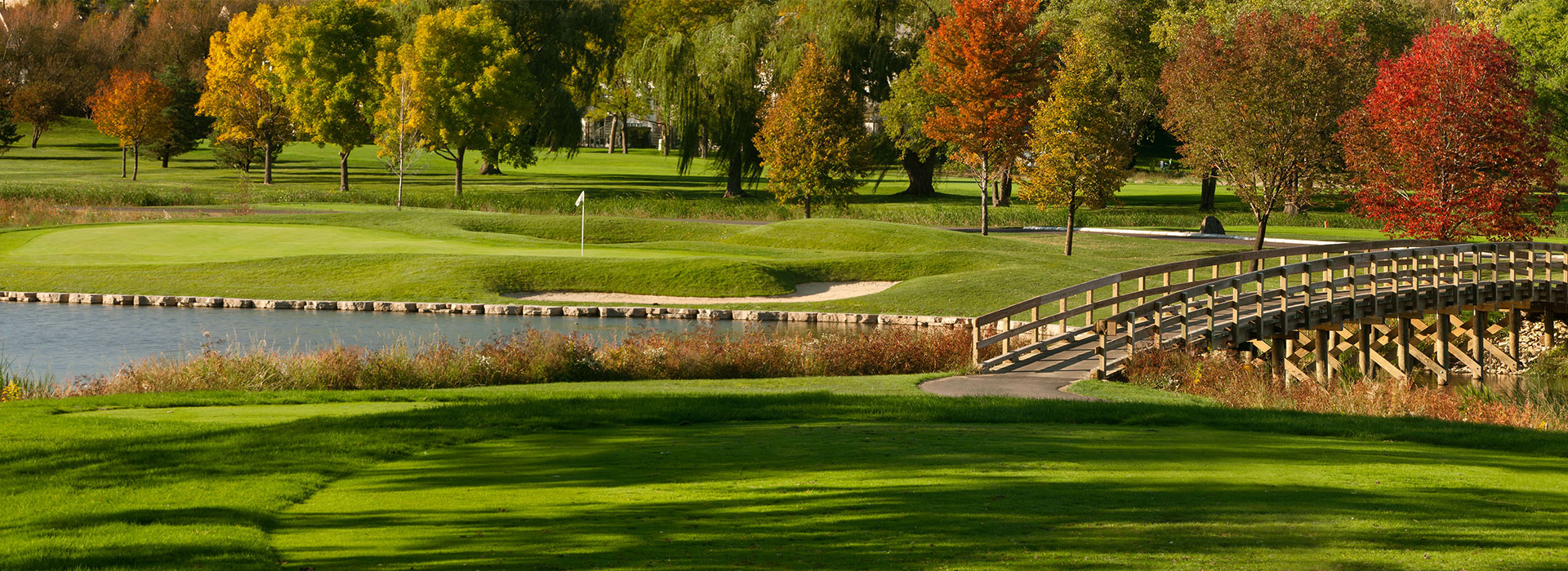 image of golf course with autumnal trees
